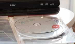A DVD disc in front of a portable player.