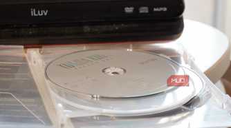 A DVD disc in front of a portable player.