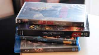A stack of Blu-ray and DVD cases.