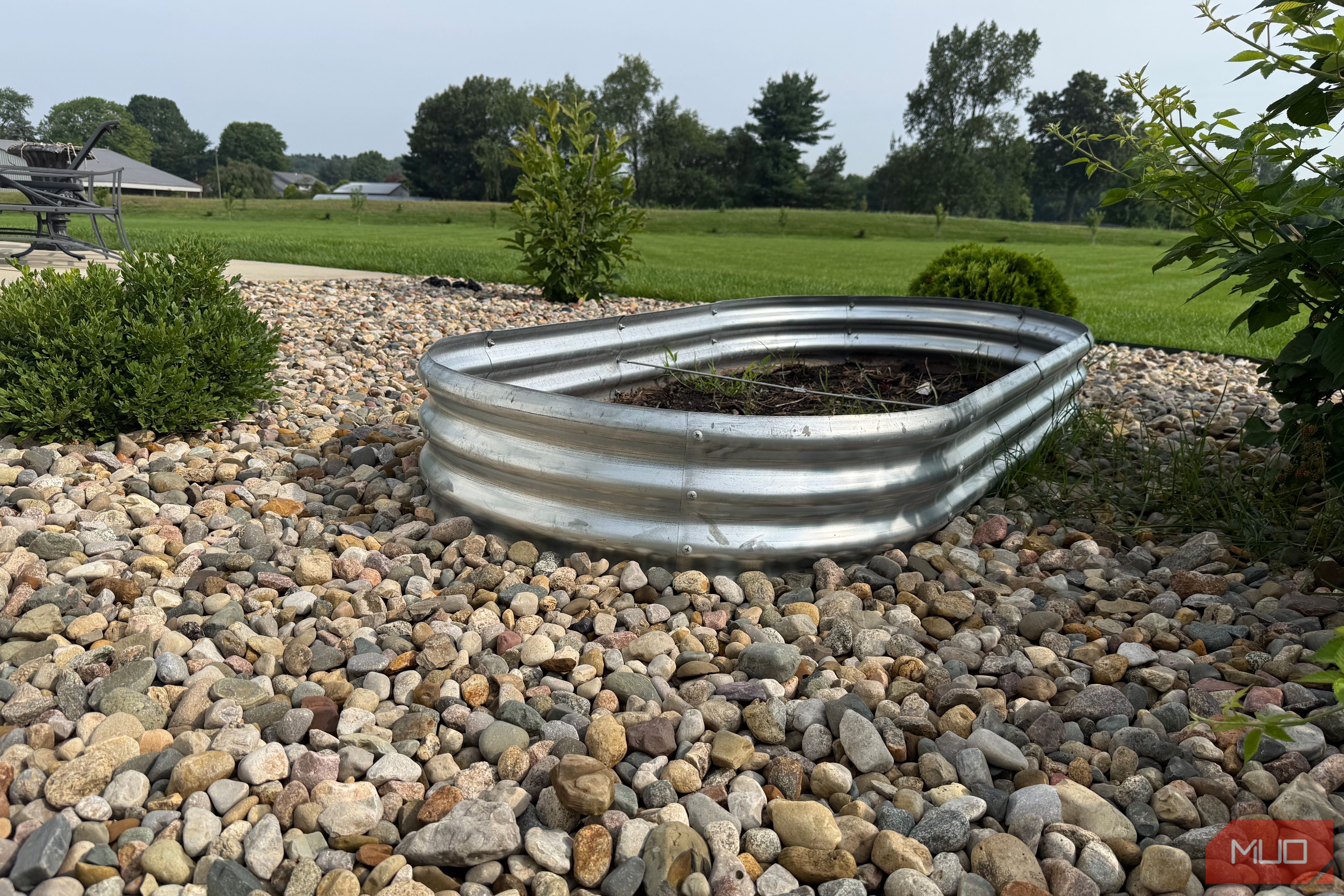 Galvanized Oval Raised Garden Bed on Gravel With Lawn View-1