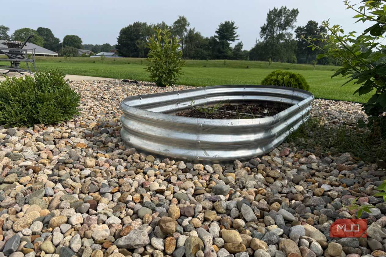 Galvanized Oval Raised Garden Bed on Gravel With Lawn View-1