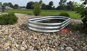 Galvanized Oval Raised Garden Bed on Gravel With Lawn View-1