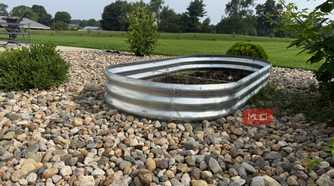 Galvanized Oval Raised Garden Bed on Gravel With Lawn View-1