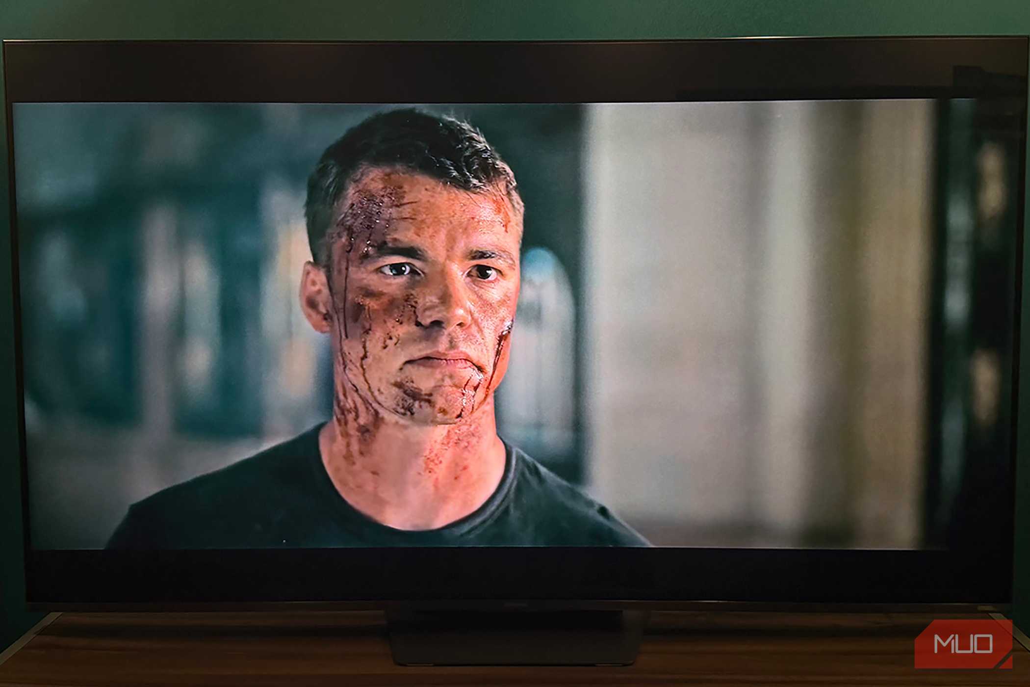 A bloody Peter in a scene from The Night Agent playing on a Hisense TV.