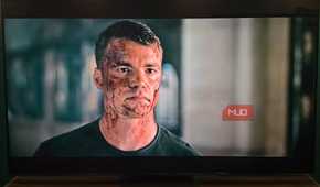 A bloody Peter in a scene from The Night Agent playing on a Hisense TV.