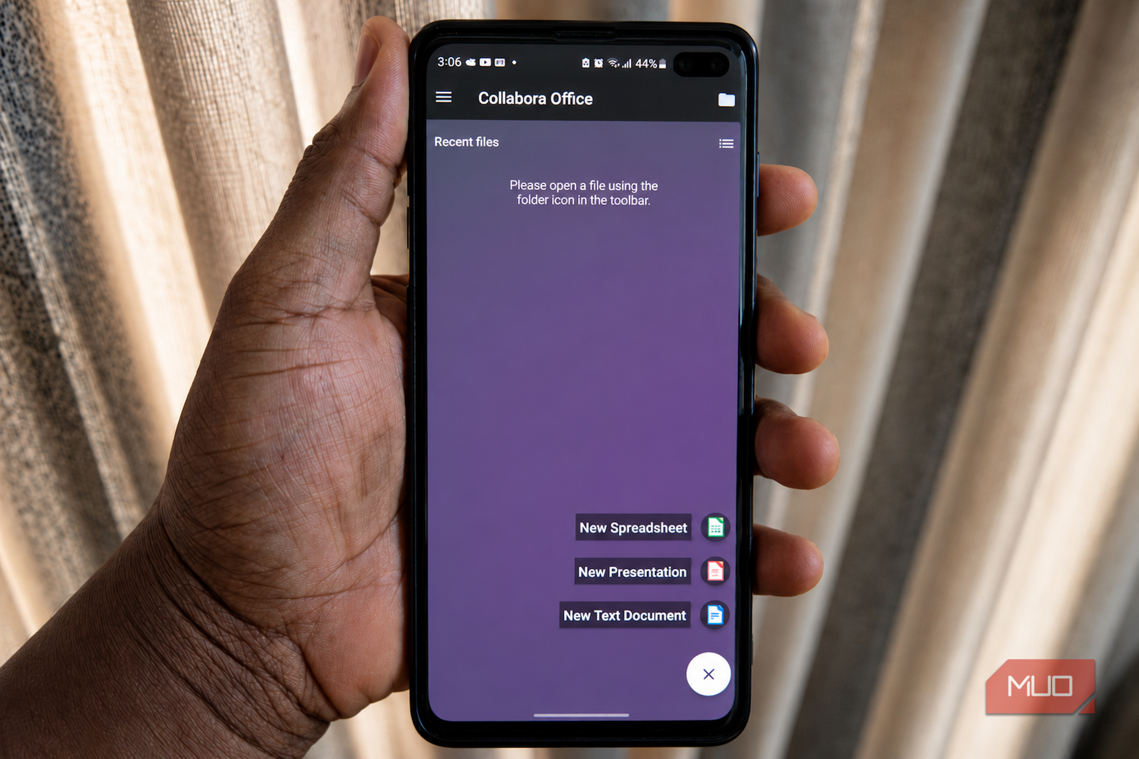Holding phone displaying Collabora Office app.
