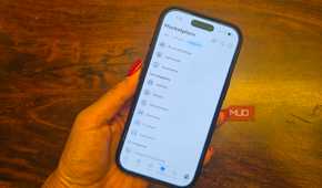 An iPhone in hand showing categories of items on Facebook Marketplace.