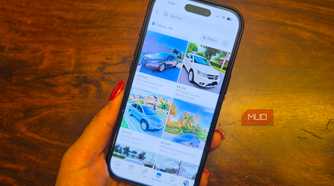 An iPhone in hand showing car listings on Facebook Marketplace.