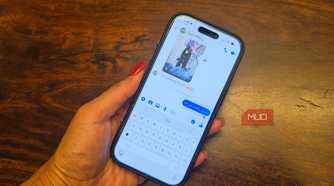 An iPhone in hand showing a Facebook Messenger conversation.