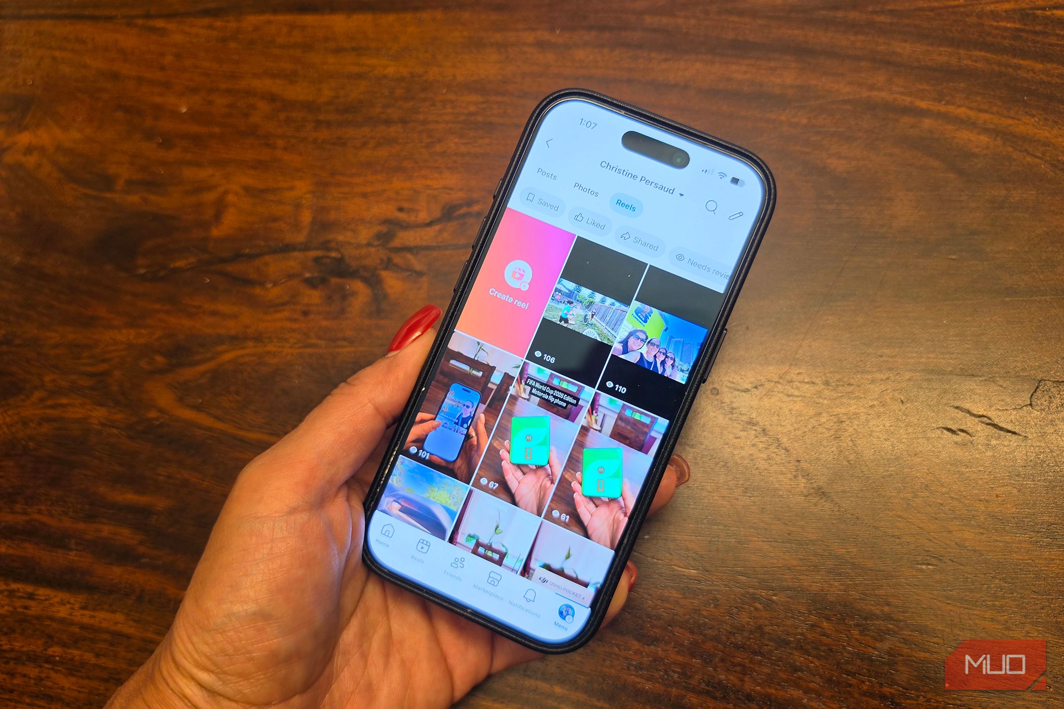 An iPhone in hand showing Facebook Reels.