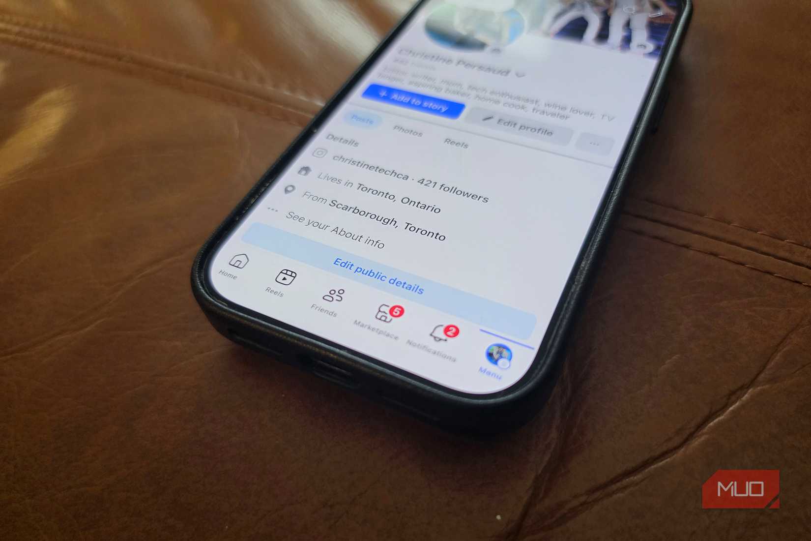 An iPhone on an angle with the Facebook app open showing notifications.