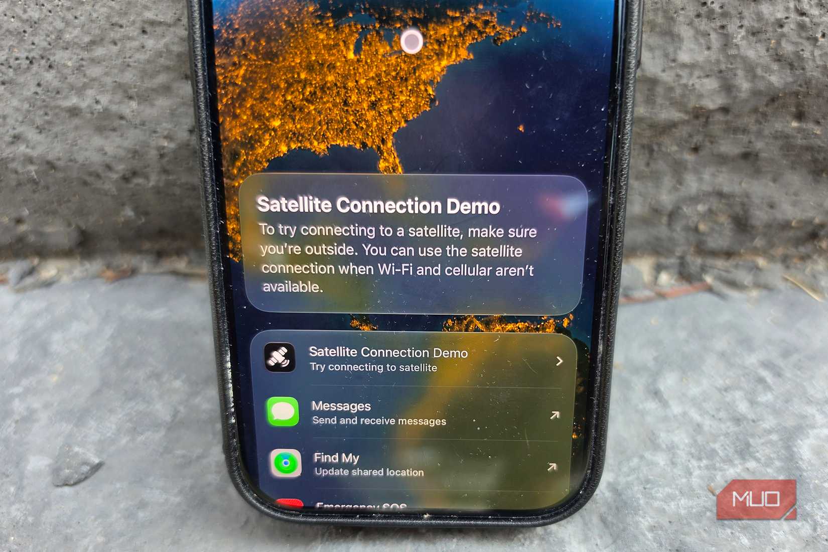 Close-up of an iPhone showing a satellite connection demo.