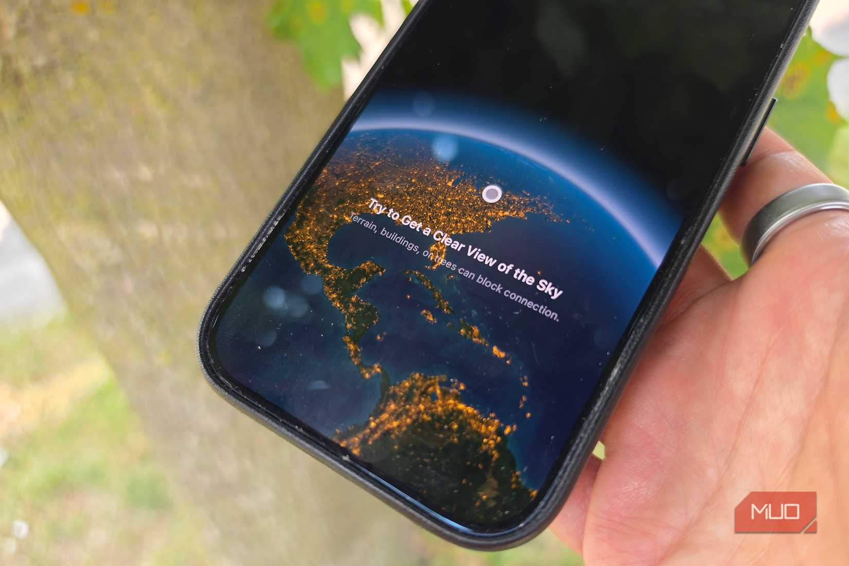 Close-up of an iPhone showing satellite trying to connect.