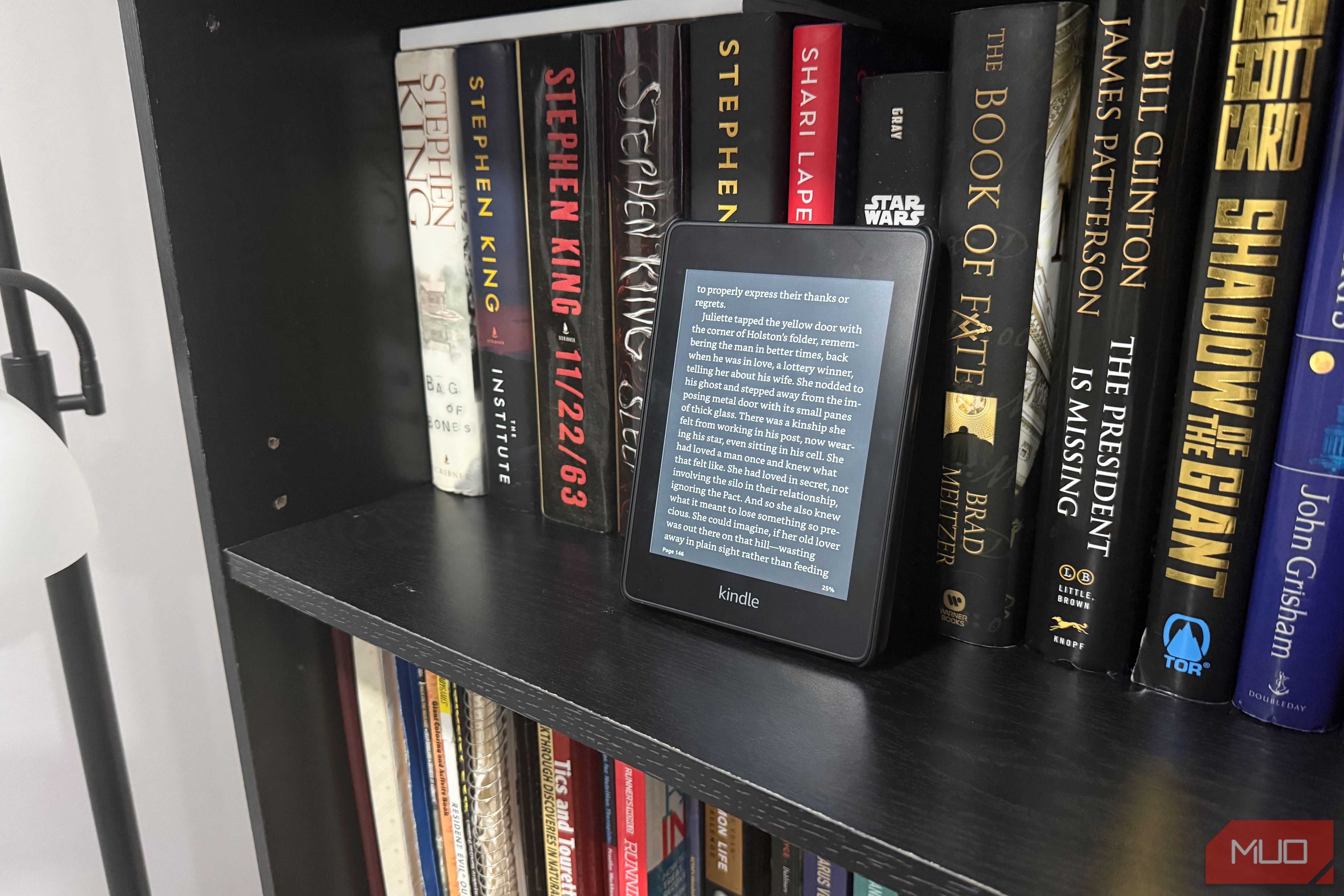 kindle paperwhite on black book shelf
