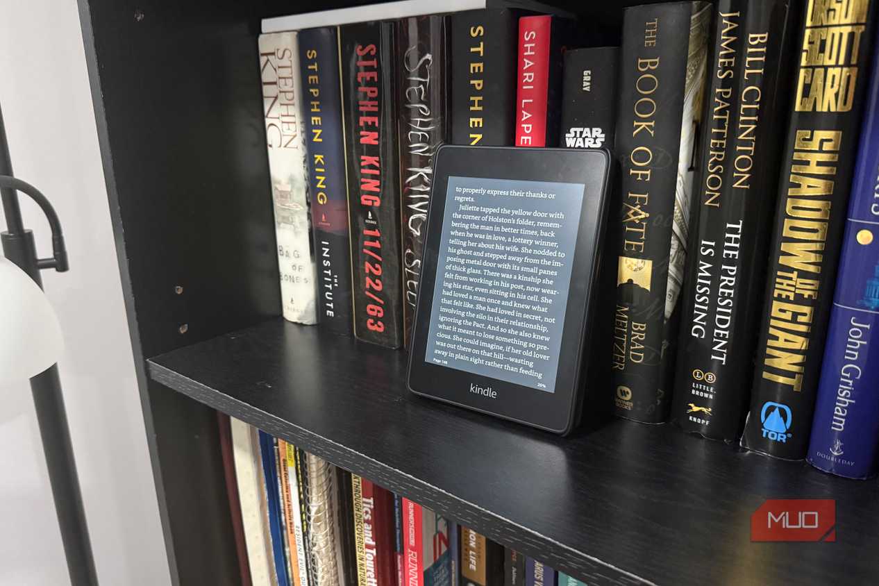 kindle paperwhite on black book shelf