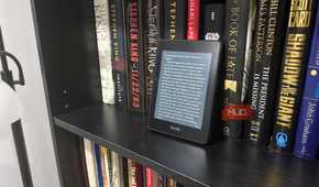 kindle paperwhite on black book shelf