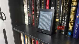 kindle paperwhite on black book shelf