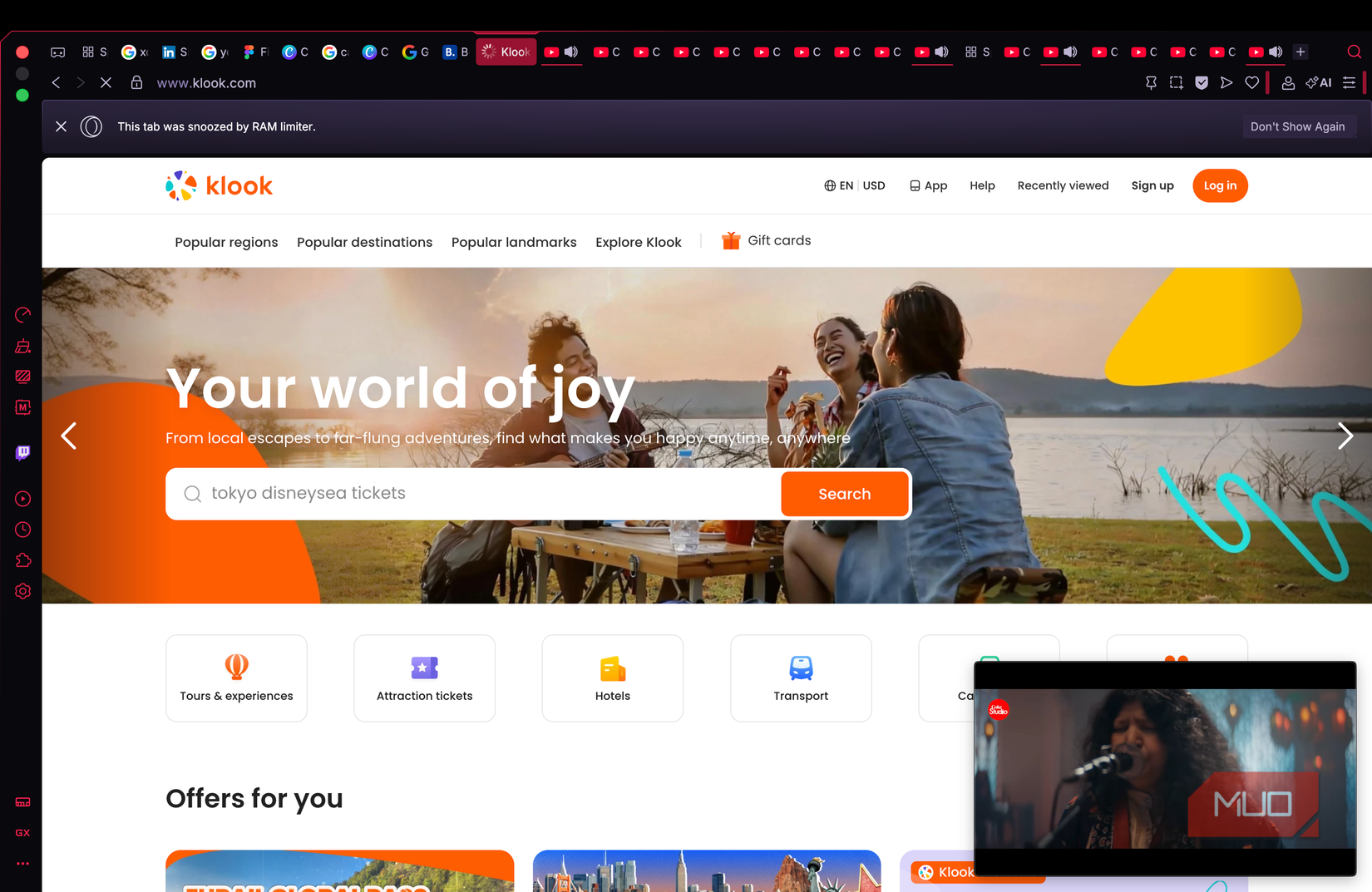 Klook travel site homepage in Opera GX with a Coke Studio video playing picture-in-picture