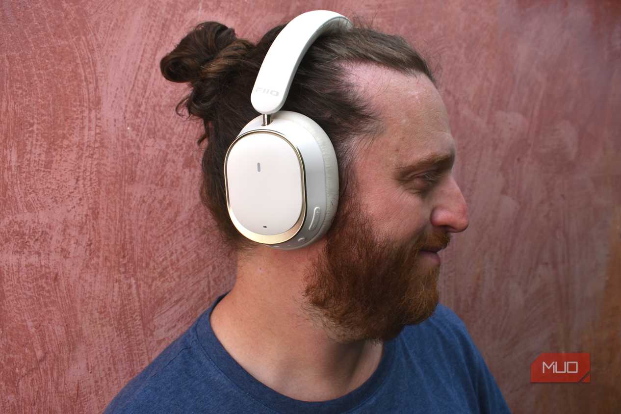 man wearing fiio eh13 headphones turned to the side.