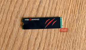 MSI Gaming M.2 NVMe SSD with a claw logo on a wooden desk