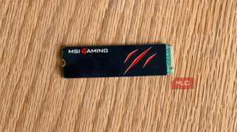 MSI Gaming M.2 NVMe SSD with a claw logo on a wooden desk