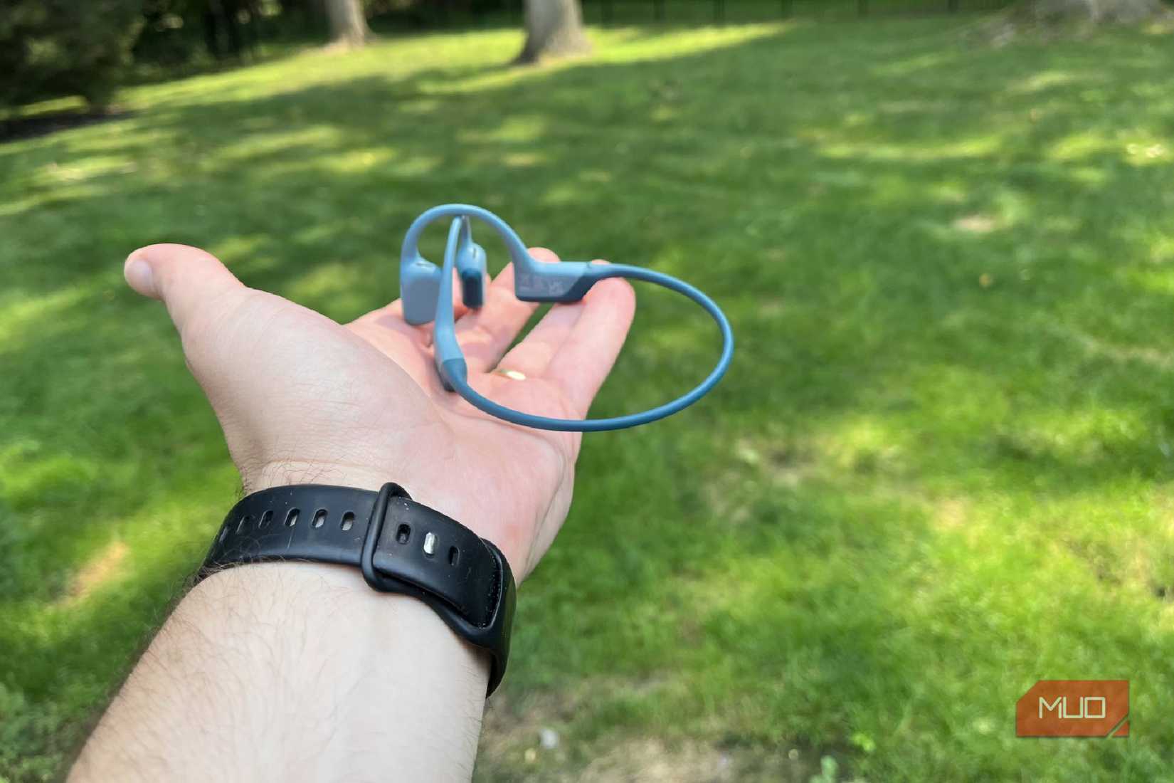 Shokz OpenRun Pro flat in someone's hand.