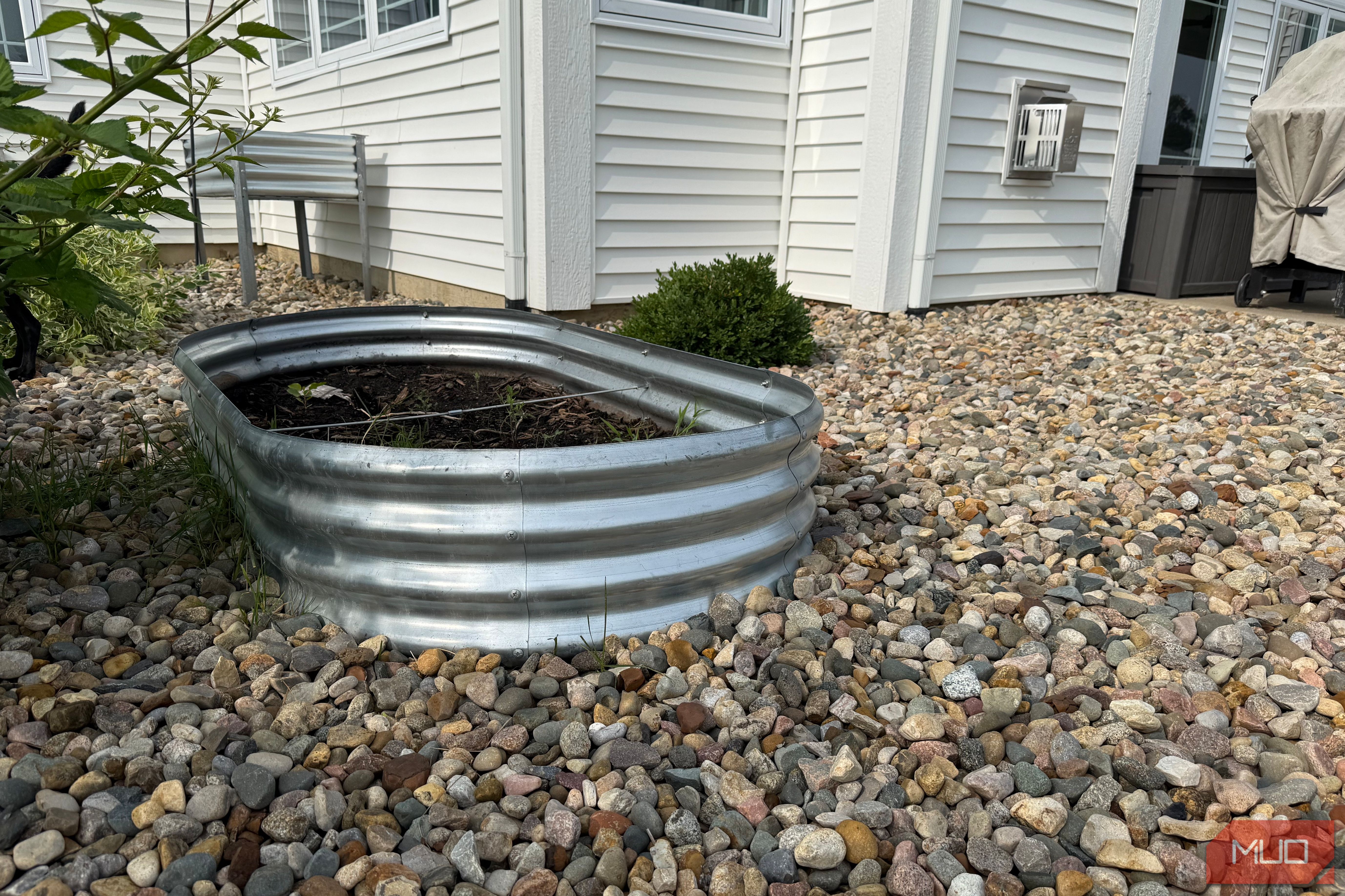 Oval Galvanized Raised Garden Bed Beside White House-1