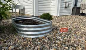 Oval Galvanized Raised Garden Bed Beside White House-1