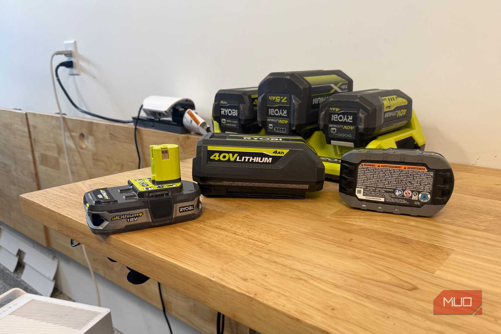 Various Ryobi 18V and 40V batteries on a table