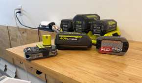 Various Ryobi 18V and 40V batteries on a table