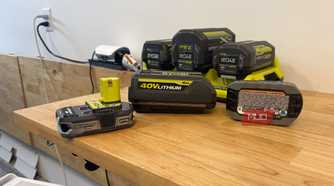 Various Ryobi 18V and 40V batteries on a table