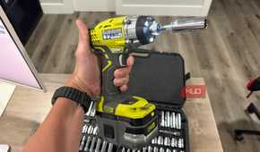 Ryobi impact driver in hand with socket adapter attached
