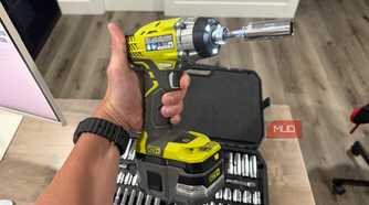 Ryobi impact driver in hand with socket adapter attached