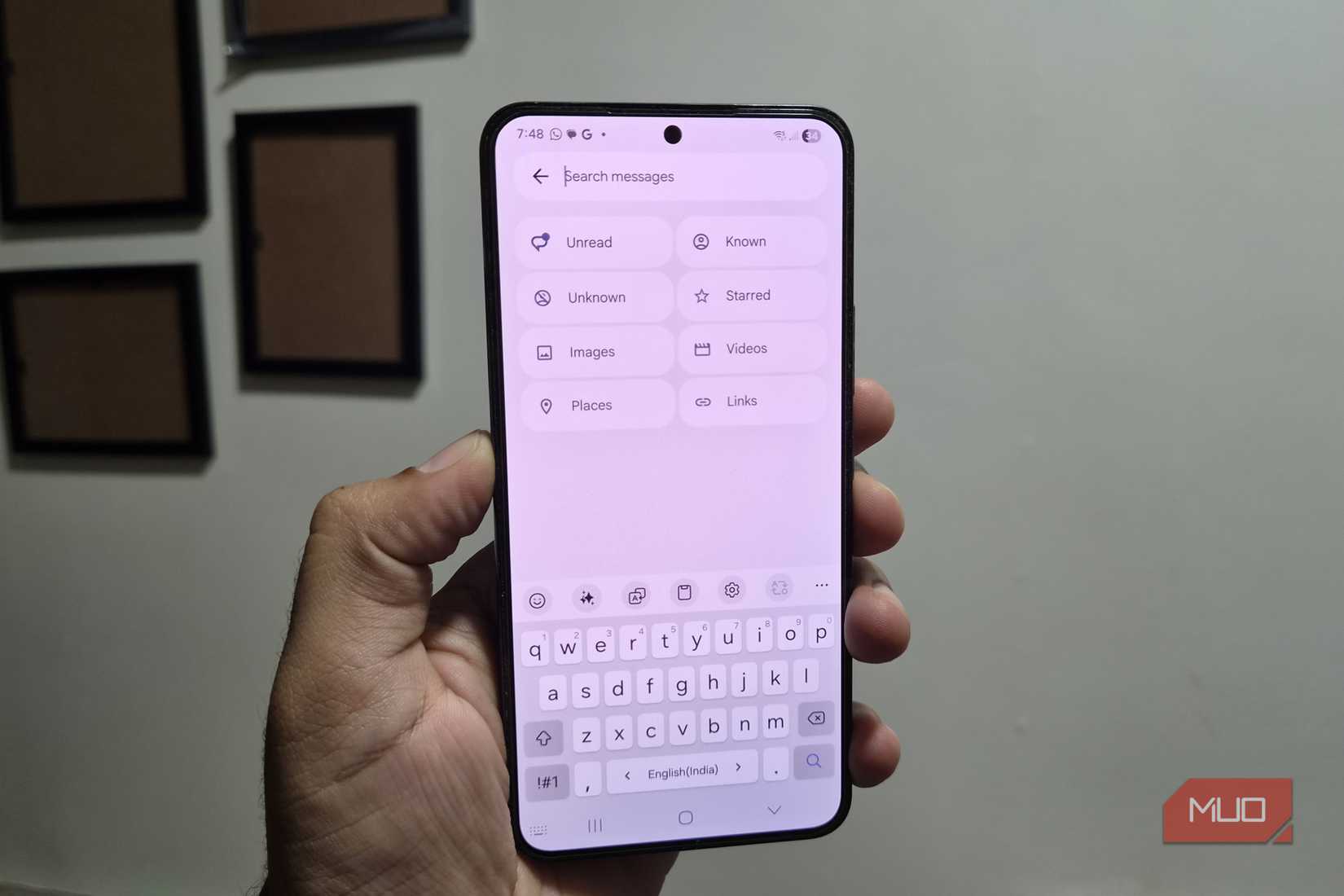 Samsung phone in hand showing search feature