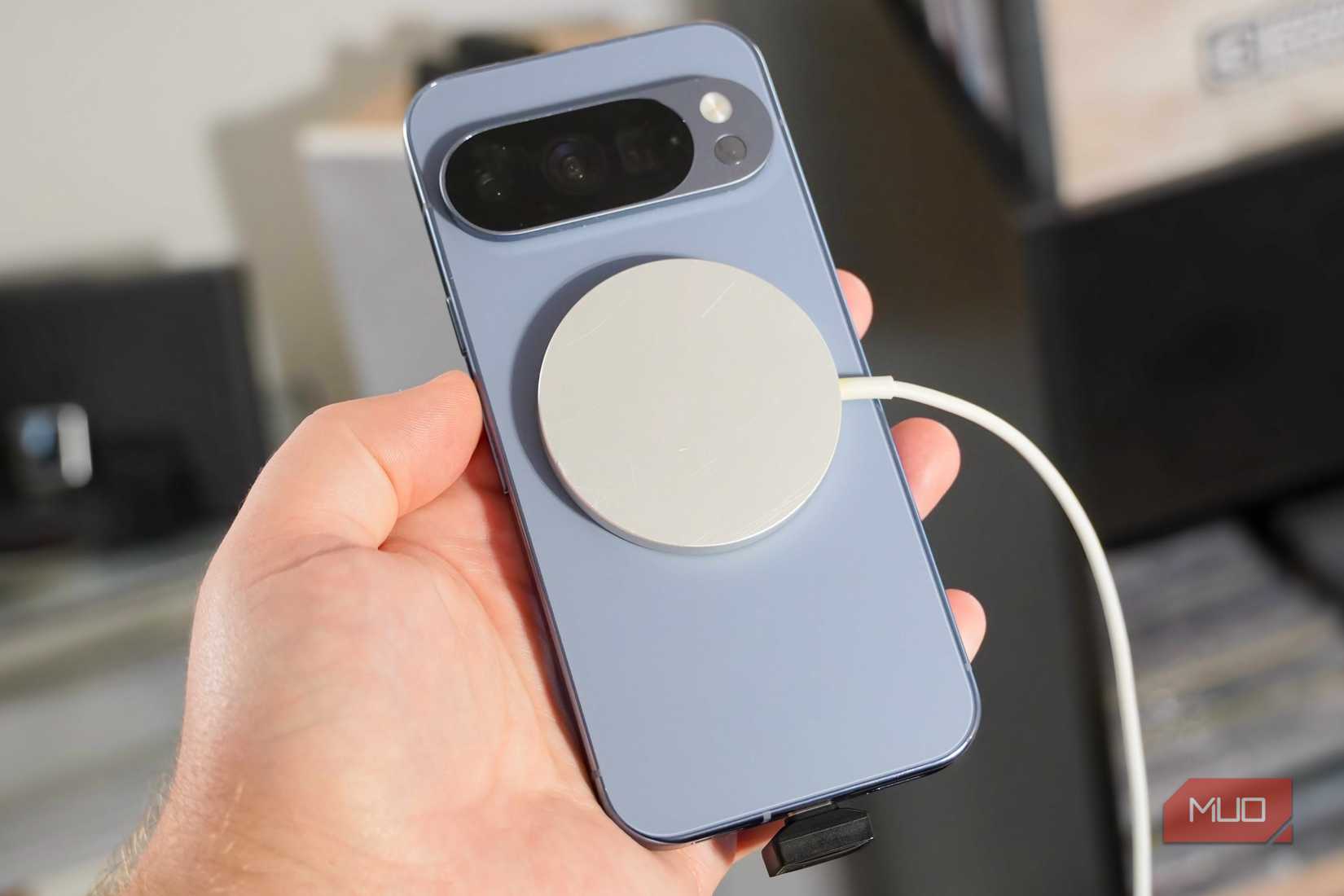 A SanDisk USB-C drive plugged into a Pixel 10 Pro while wireless charging.
