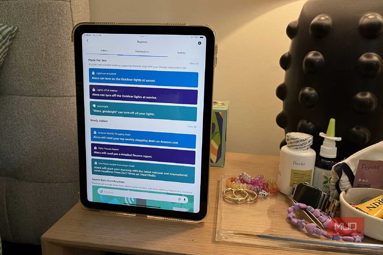 A tablet on a nightstand showing the routines in Alexa app.