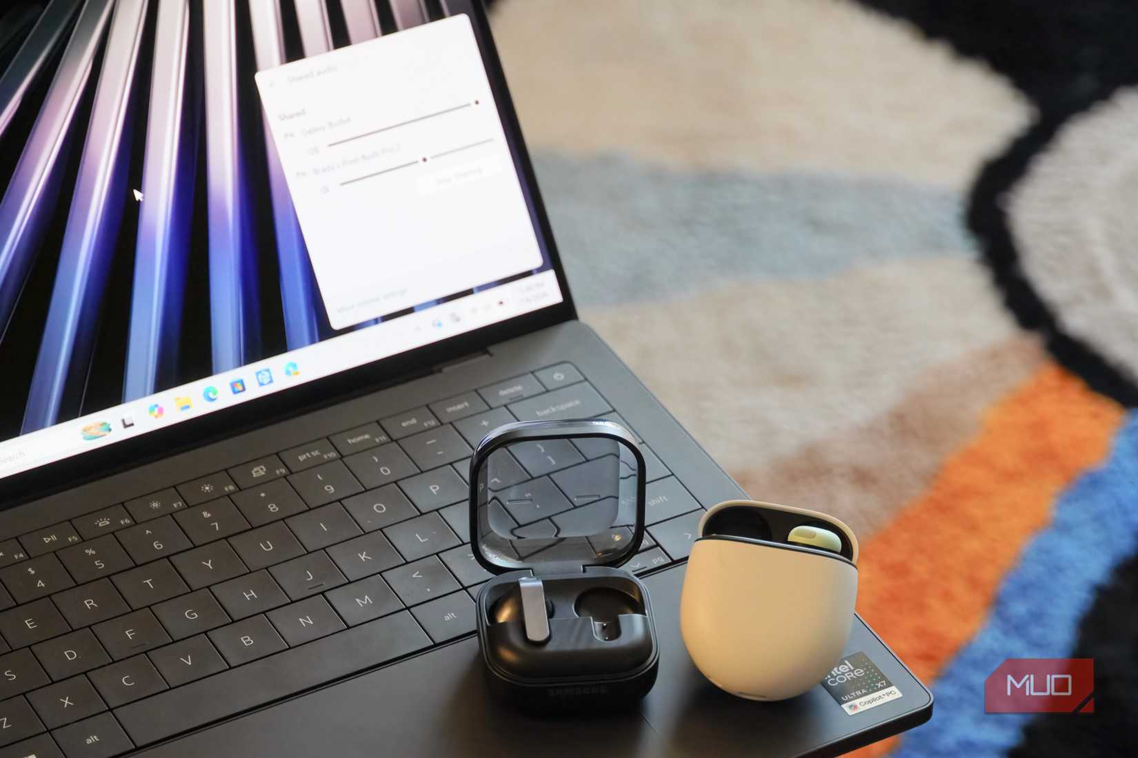 A pair of Bluetooth LE Audio earbuds on a Windows 11 laptop with audio sharing.