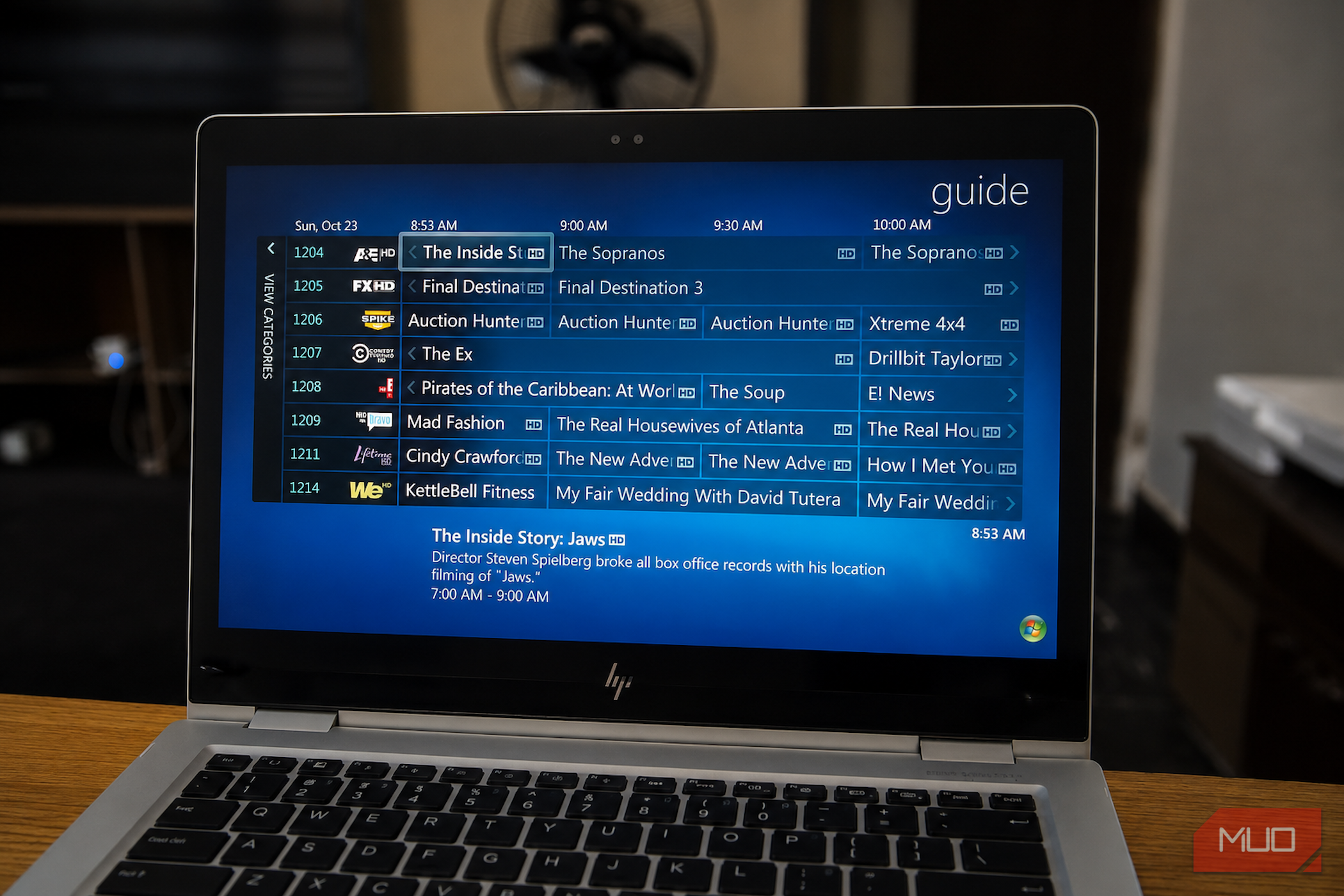 Windows Media Center TV guide on laptop.