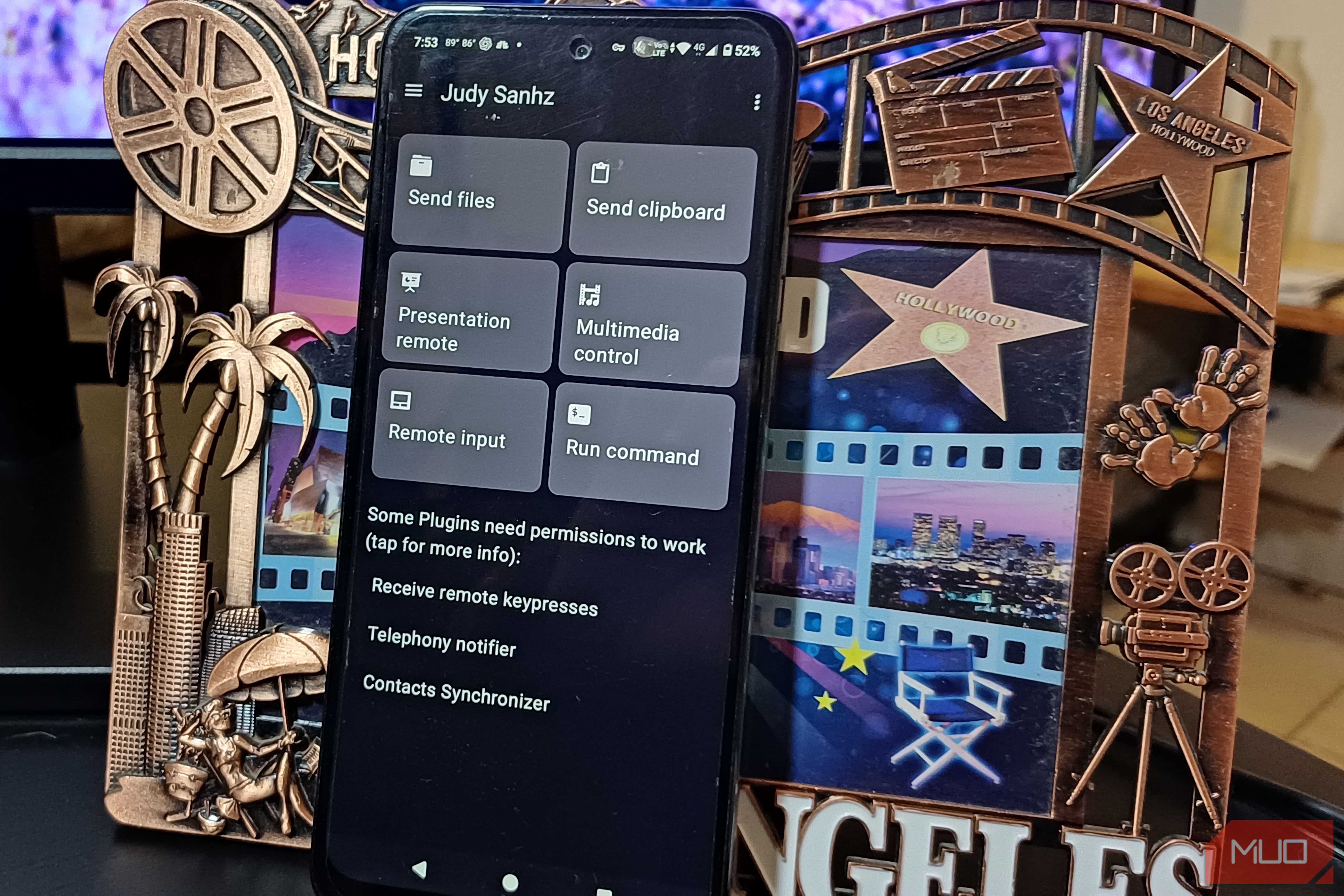 An Android phone with Zorin Connect on its display leaning on a frame