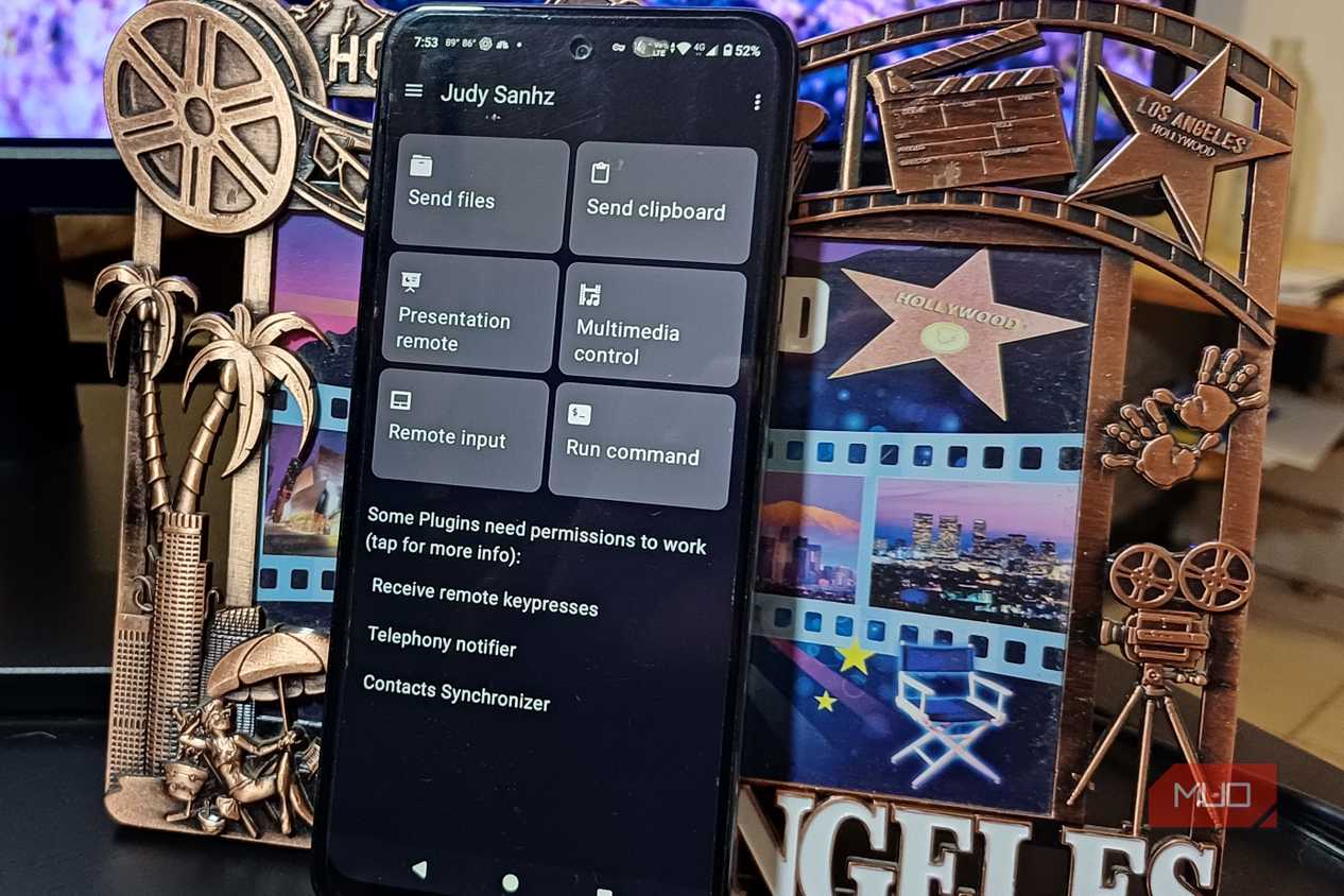 An Android phone with Zorin Connect on its display leaning on a frame