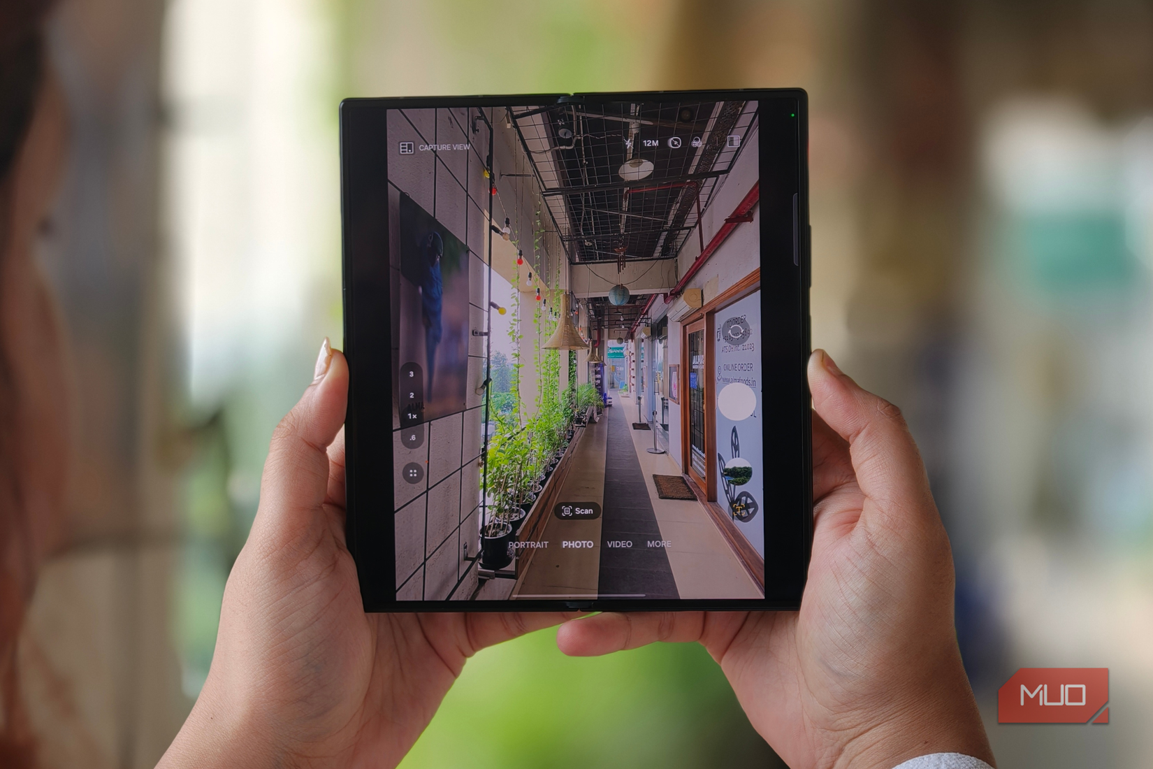 A person clicking a picture with the Samsung Galaxy Z Fold 8 Ultra