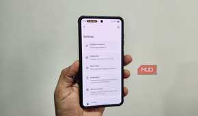 Android phone in hand showing Breezy Weather app