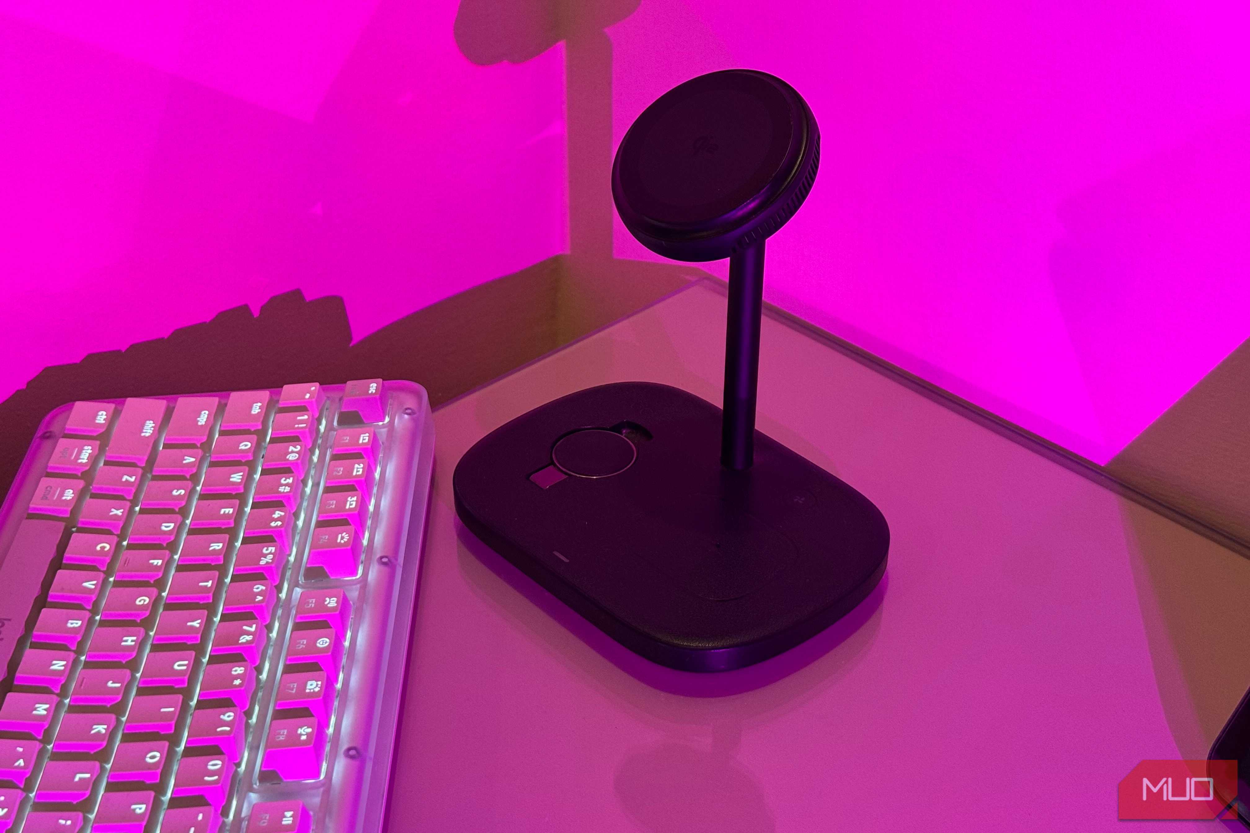 Baseus charging stand on glass desk in pink light