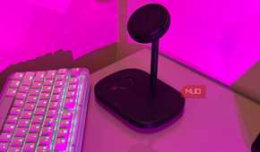 Baseus charging stand on glass desk in pink light