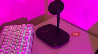 Baseus charging stand on glass desk in pink light