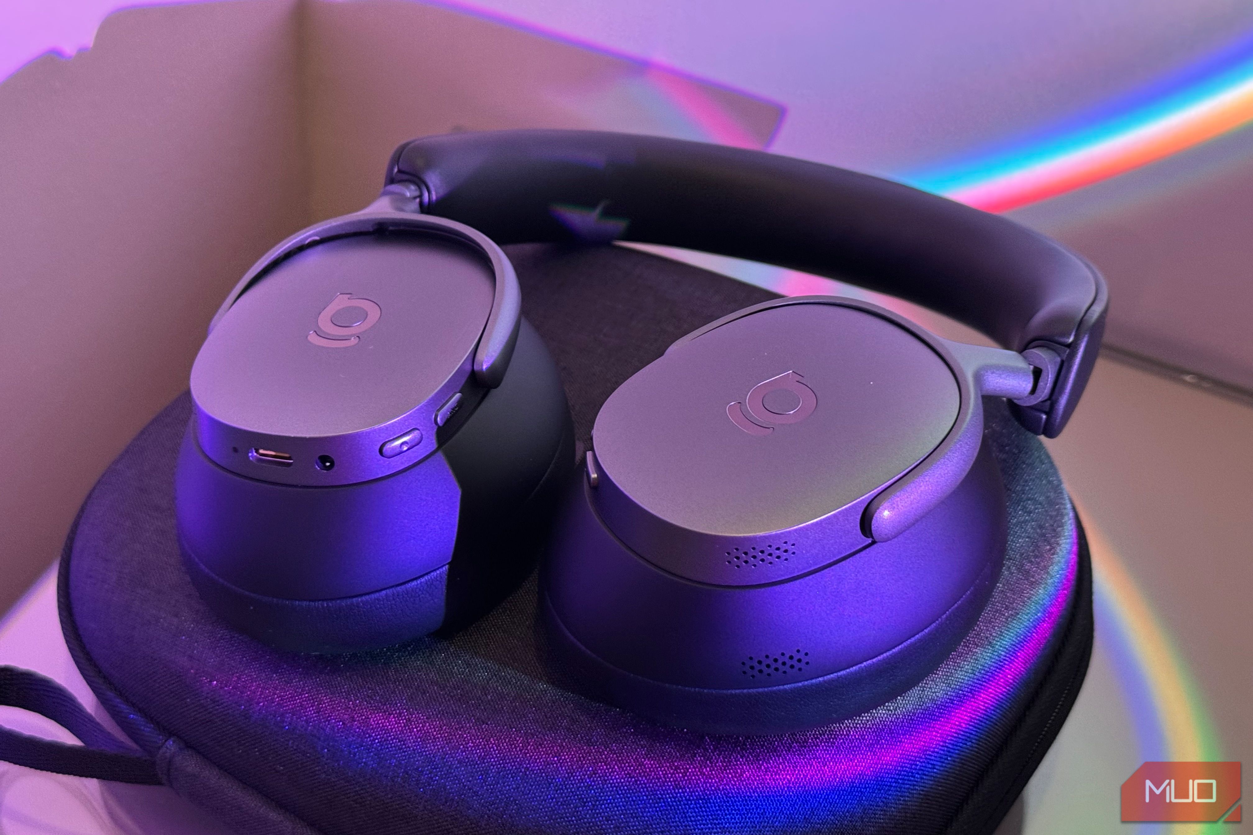 Close-up of two padded ear cushions on headphones, one leather one mesh-lined