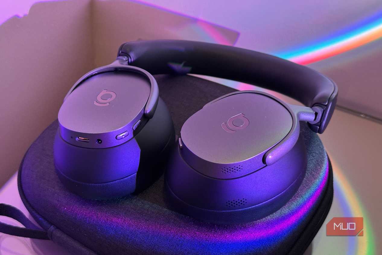 Close-up of two padded ear cushions on headphones, one leather one mesh-lined