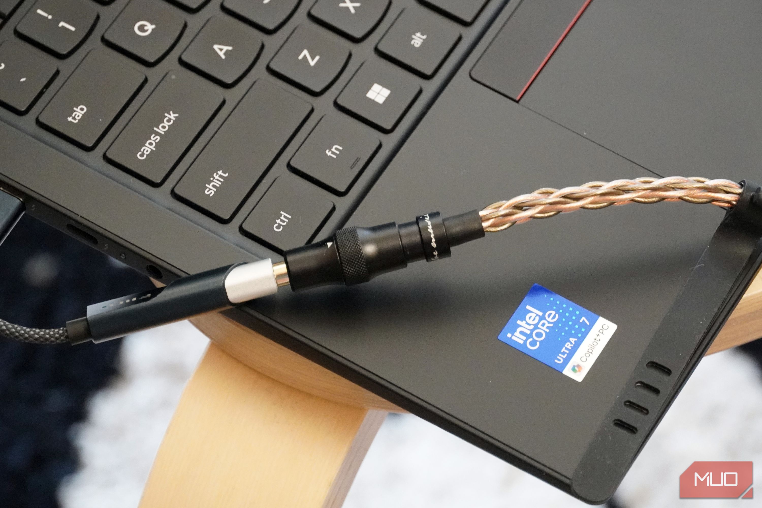 A Fiio KA11 USB-C DAC plugged into a Lenovo laptop.