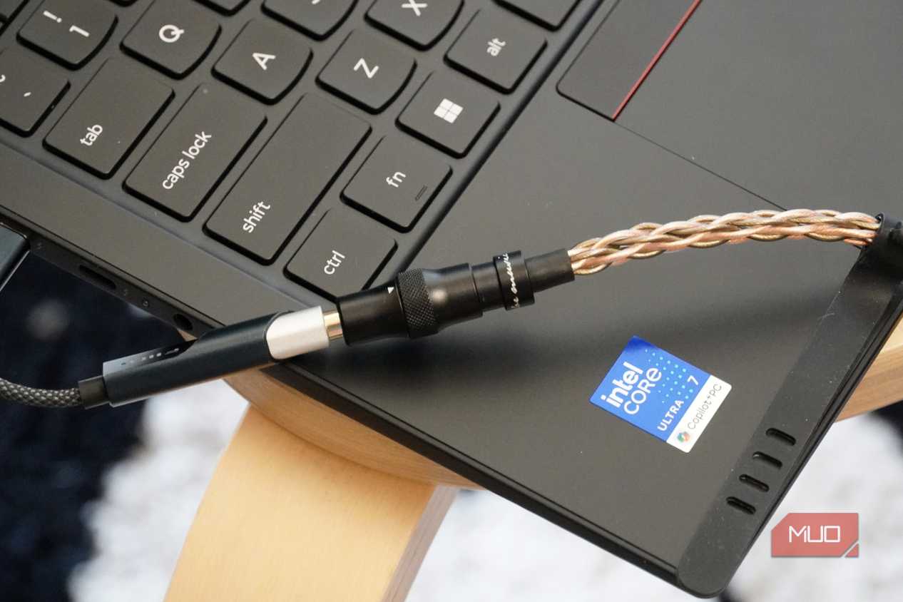 A Fiio KA11 USB-C DAC plugged into a Lenovo laptop.