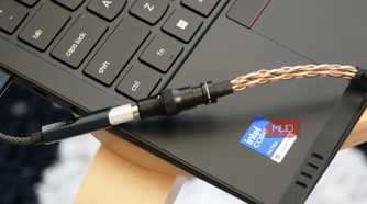 A Fiio KA11 USB-C DAC plugged into a Lenovo laptop.